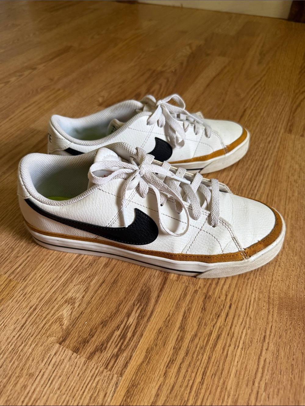 Nike White Low-Top Sneakers with Black Swoosh and Tan Accent
